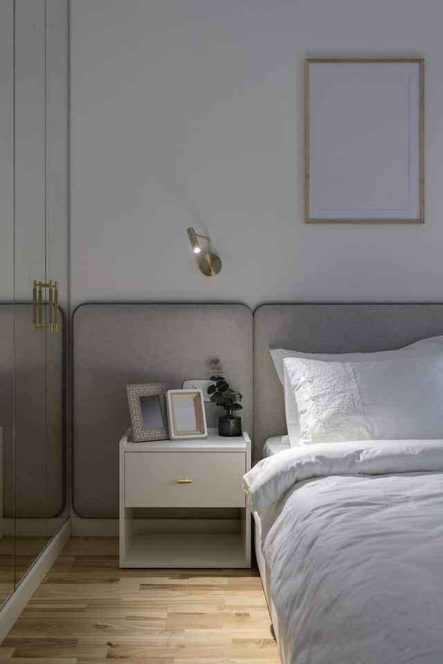 white bedside table next to bed