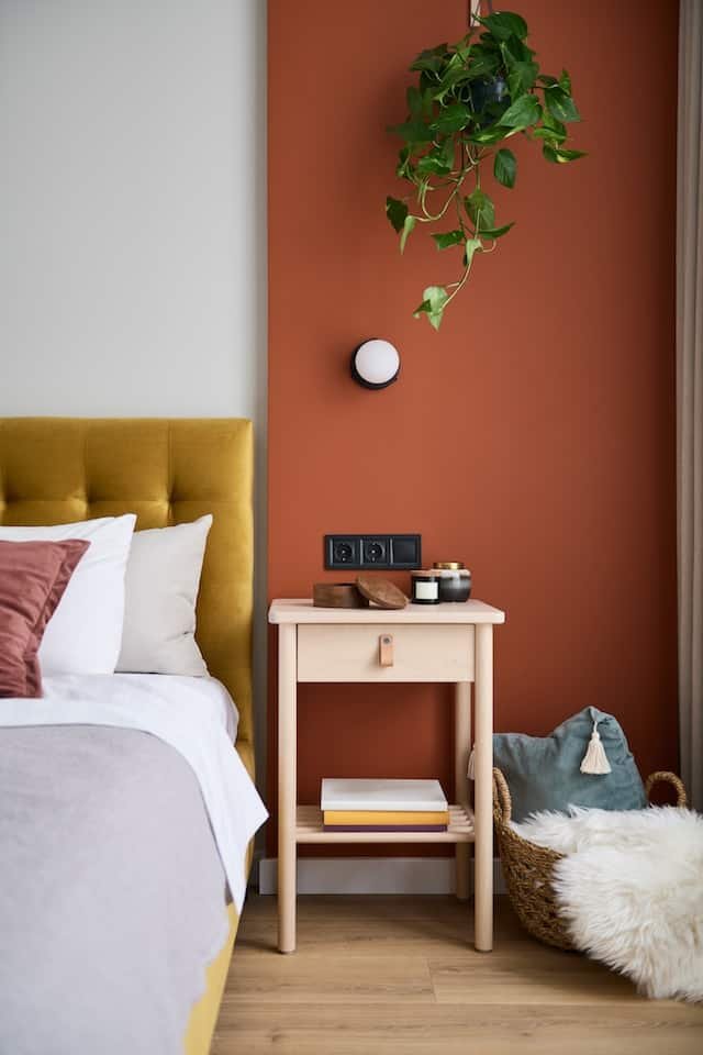 bedside table next to bed in a room