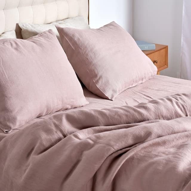 a bed with pink pillows on it